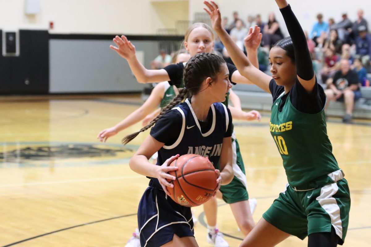 Eighth grade varsity athlete, so & so, attempts to get past the guards to take a shot.